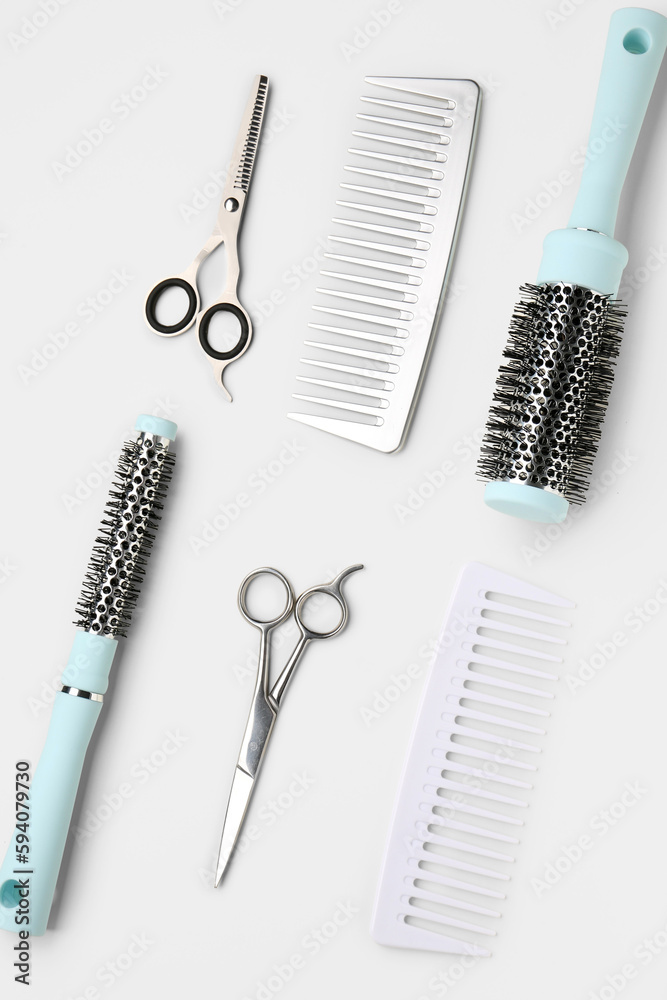 Hair brushes with scissors on light background Hair brushes with scissors on light background