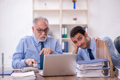 Two male colleagues working in the office