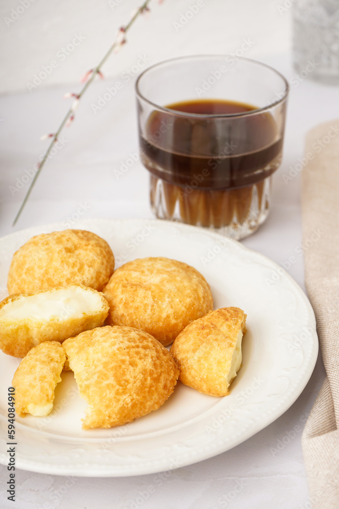 Plate with tasty choux dessert on light background, closeup Plate with tasty choux dessert on light background, closeup