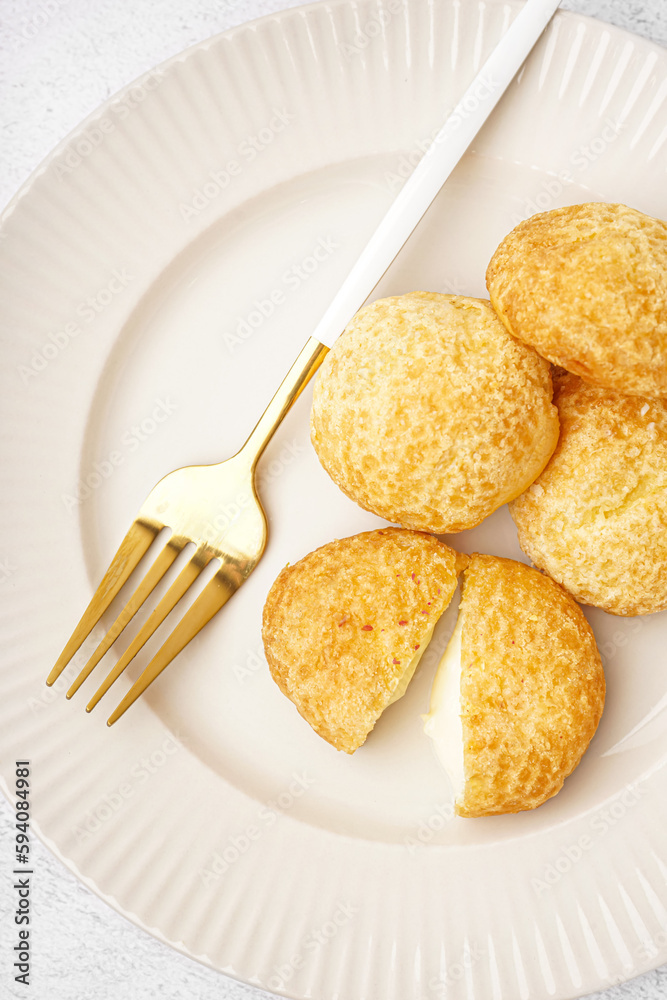 Plate with tasty choux dessert on table, closeup Plate with tasty choux dessert on table, closeup
