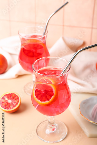 Glass of tasty blood orange lemonade on table