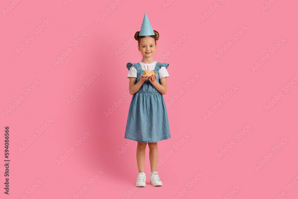 Cute Little Girl In Party Hat Holding Birthday Cake Piece With Candle