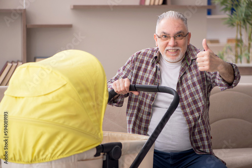 Old man looking after newborn at home