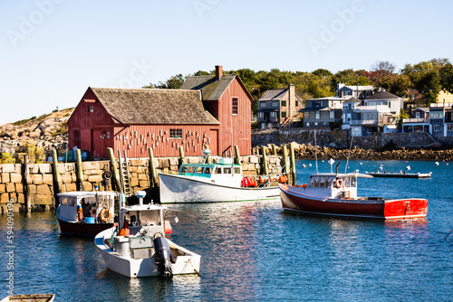 Afternoon sun illuminating Motif Number 1 and lobster boats, Bradley Wharf, Rockport, MA.  photo