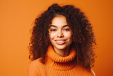 Happy fun loving multiethnic female posing in the studio. Energetic young afro-american woman isolated on orange background. Generative AI.