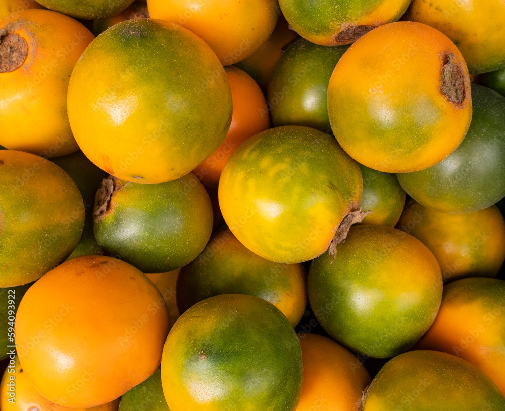 Solanum quitoense - Naranjilla tropical fruit in Colombian market square