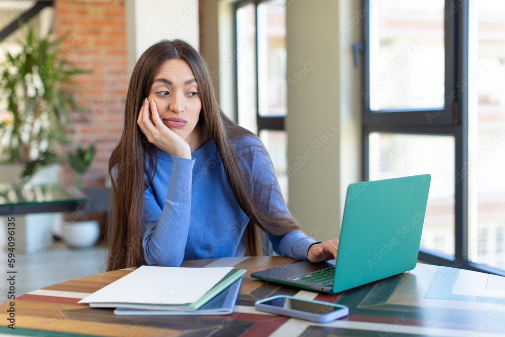feeling bored, frustrated and sleepy after a tiresome. laptop and desk concept feeling bored, frustrated and sleepy after a tiresome. laptop and desk concept
