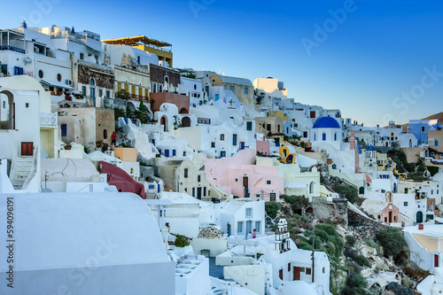 Scenic view of Oia village with Pastel colored houses and churches over the caldera of Oia village in Santorini