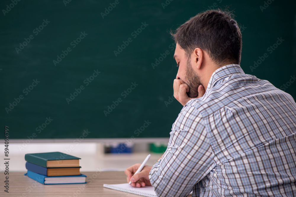 Young male student sitting in the classroom Young male student sitting in the classroom