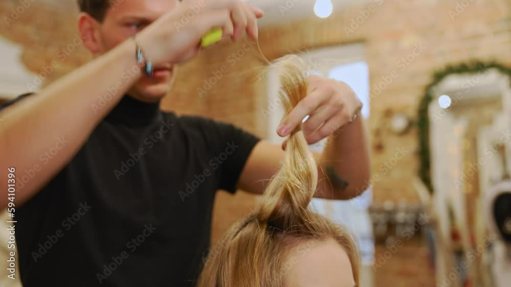 Professional barber trimming front layers of his female client with blond hair. High quality 4k footage Professional barber trimming front layers of his female client with blond hair. High quality 4k footage