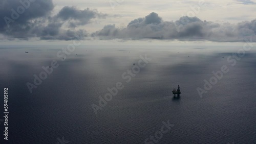 Jack up drilling rig and production platform in the middle of the ocean during couldy time
 photo