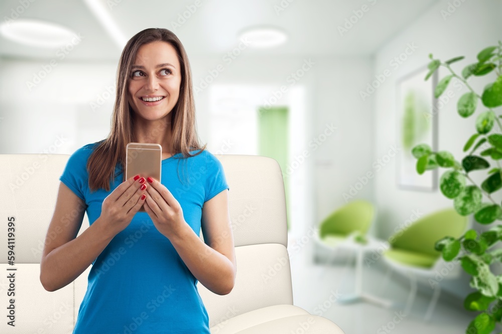 Young attractive woman holding a smart phone Young attractive woman holding a smart phone