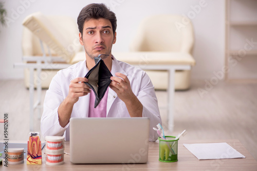Young male dentist working in the clinic