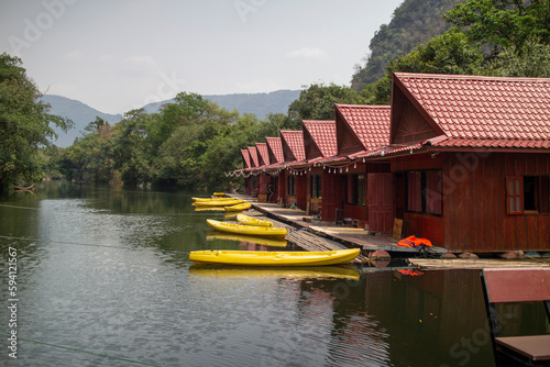 Houses on floating rafts with kayaks for tourists at Tha Farang, Thakhek City, Khammouane Province, Laos. photo