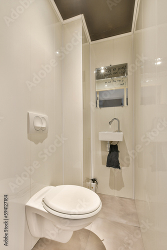 a white bathroom with a toilet and mirror in the shower stall  it appears to be used as a public restroom