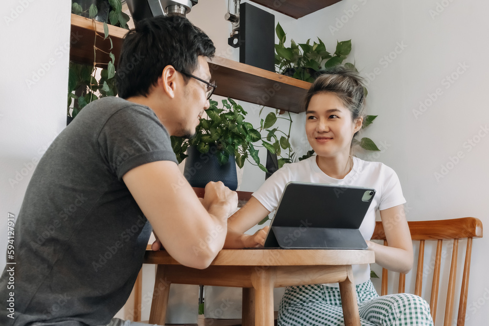 Asian man and woman dealing business agreement and contract in relaxing office. Asian man and woman dealing business agreement and contract in relaxing office.