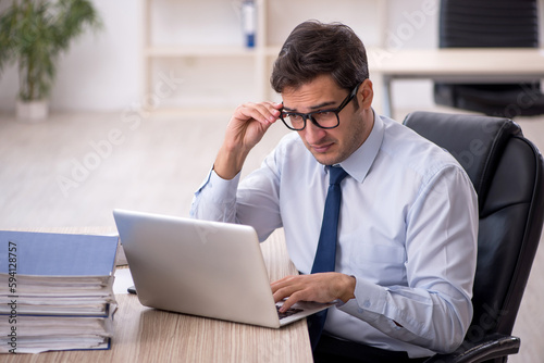 Young male employee working in the office