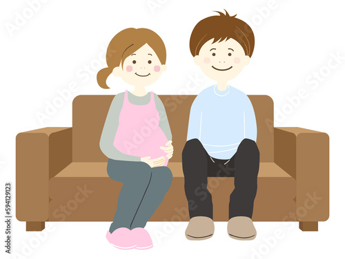 ソファーに座る妊娠中の妻と夫