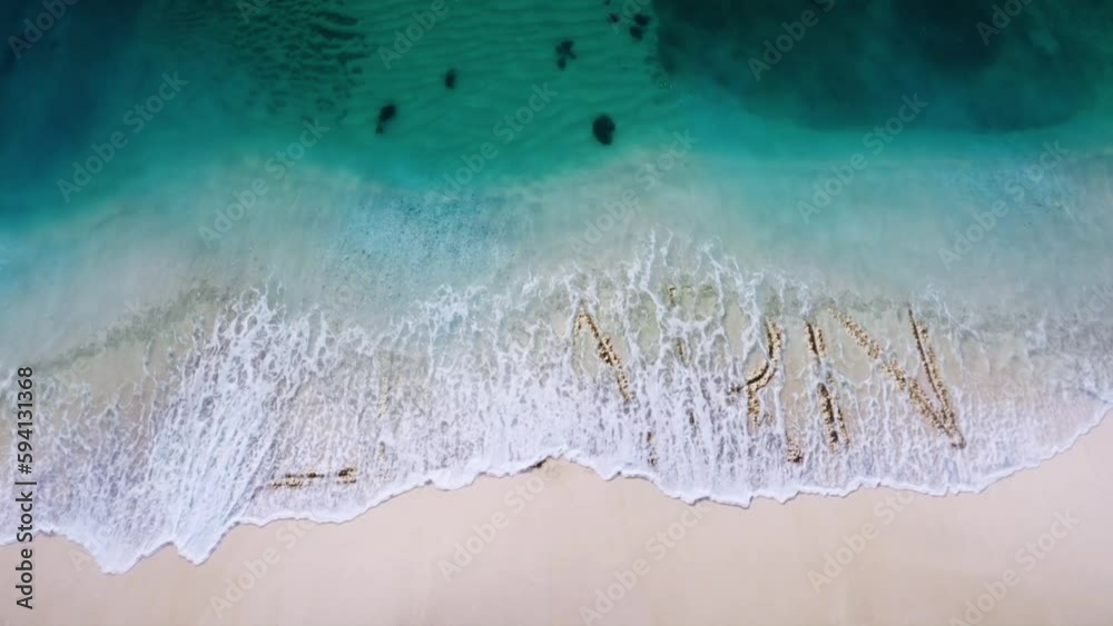 learn earn letter  written on the beach sand and erased with a wave,and reveals  a new letter  concept video 