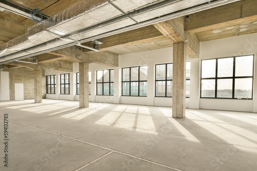 an empty office building with lots windows and light coming in from the sun shining through the window panoray