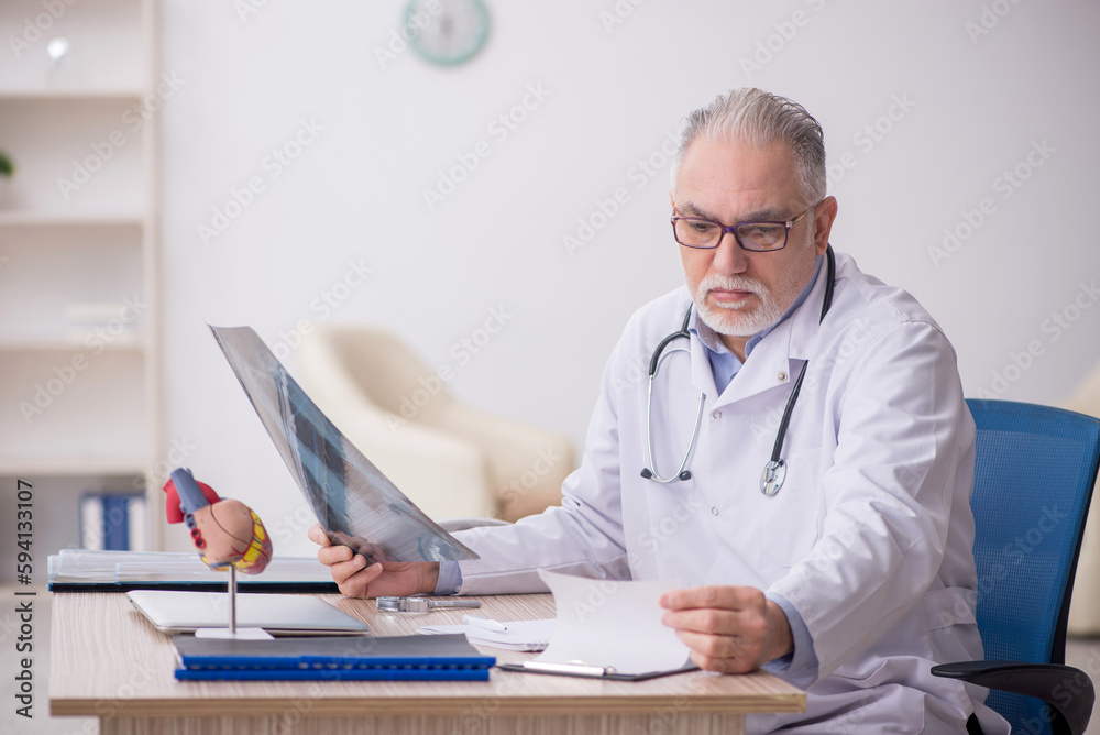 Old male doctor radiologist working at the hospital Old male doctor radiologist working at the hospital