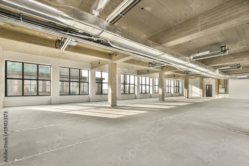 an empty office space with lots windows and light coming in from the sun shining through the window panoray