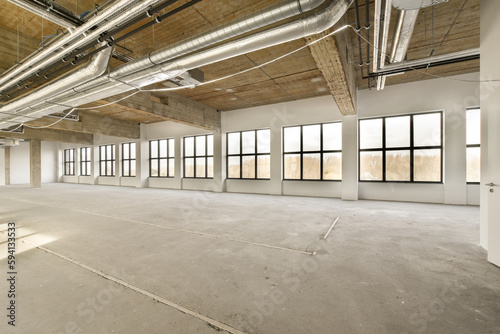an empty office space with exposed ceiling and large windows in the room is very clean  ready to be used