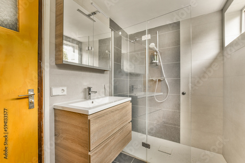 a bathroom with a yellow door and white tiles on the wall behind it is a wooden vanity  sink and mirror