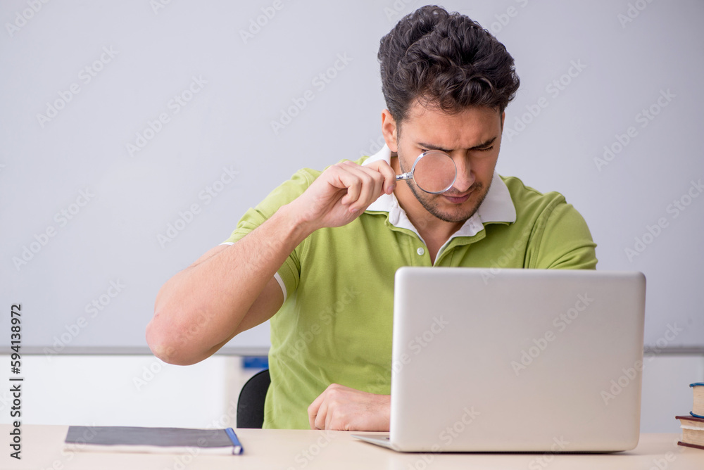 Young male student in telestudying concept Young male student in telestudying concept