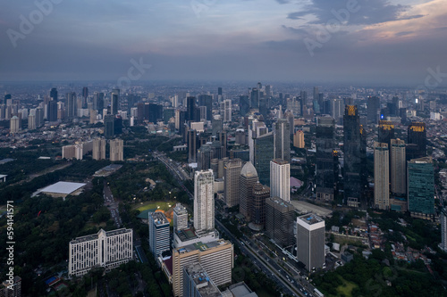 aerial shoot of Jakarta skyline during the golden hour. Jakarta is the capital city of indonesia that also one of the most populated city in the world. © alfin