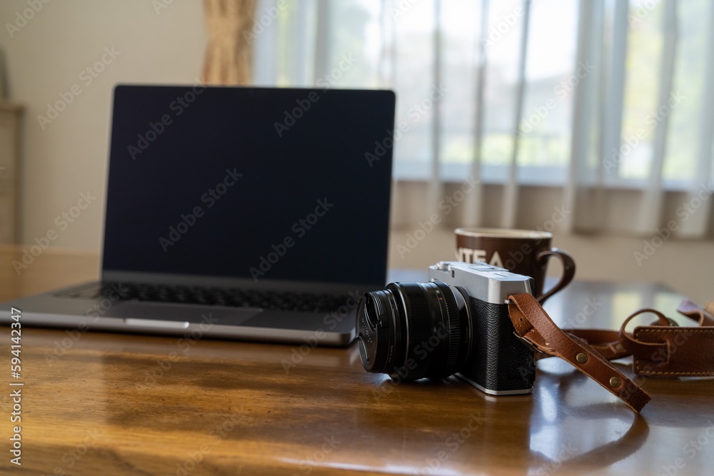 Obraz premium リビングの机の上のカメラとパソコン