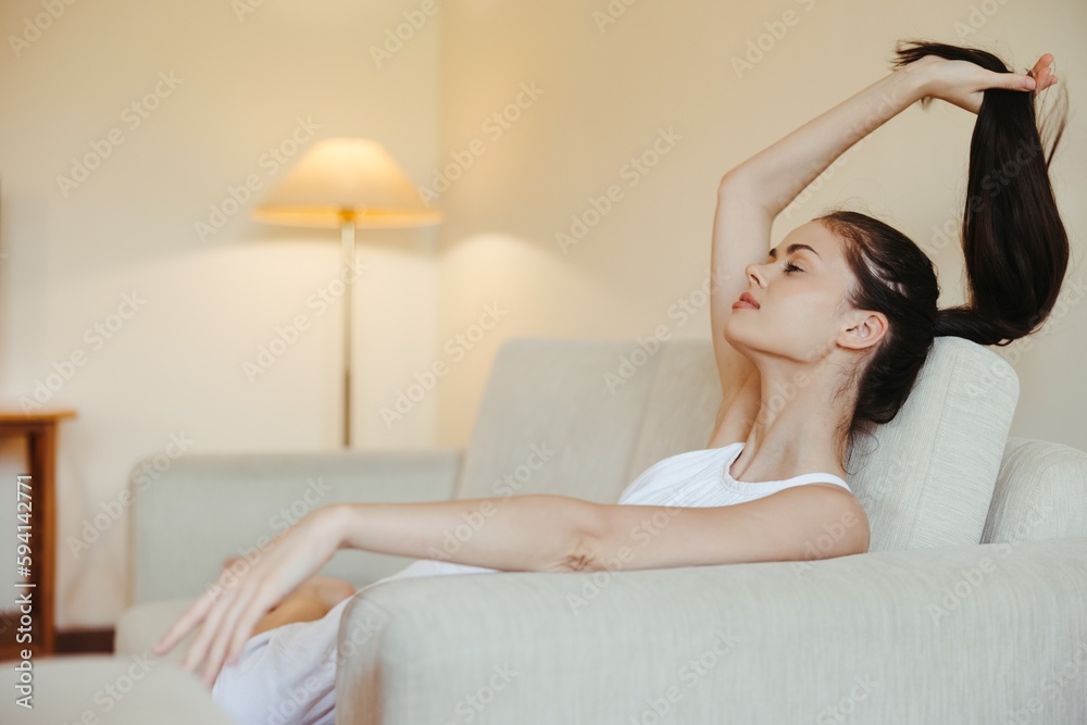 Obraz premium Happy girl smile lying on the couch at home, relaxing at home, comfort, sunshine.