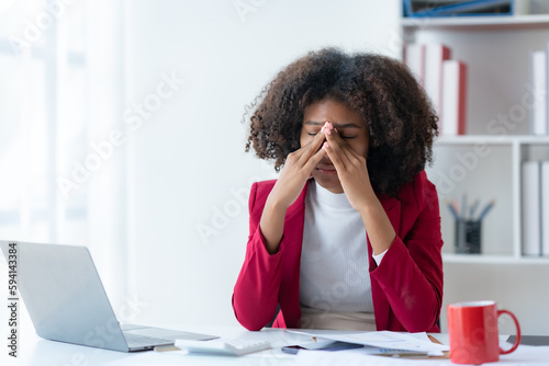 Tablou pe pânză Businesswoman curly hair stressed with overwork in the office.