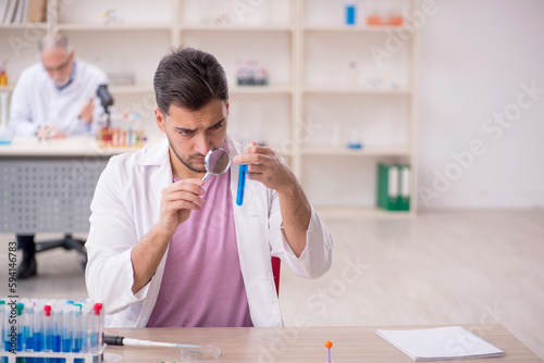 Two male chemists working at the lab