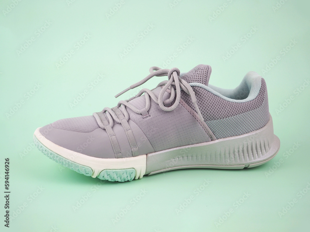 New Grey-light green sneakers isolated on green background. Unisex sports footwear, fashion style pair of casual sports shoes, Mock-up for sneaker design, logo, a product of sport. ..