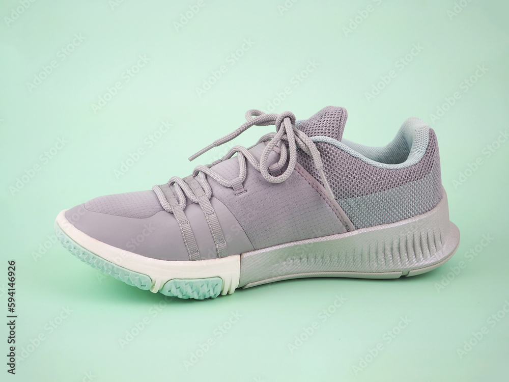 New Grey-light green sneakers isolated on green background. Unisex sports footwear, fashion style pair of casual sports shoes, Mock-up for sneaker design, logo, a product of sport. .. New Grey-light green sneakers isolated on green background. Unisex sports footwear, fashion style pair of casual sports shoes, Mock-up for sneaker design, logo, a product of sport. ..
