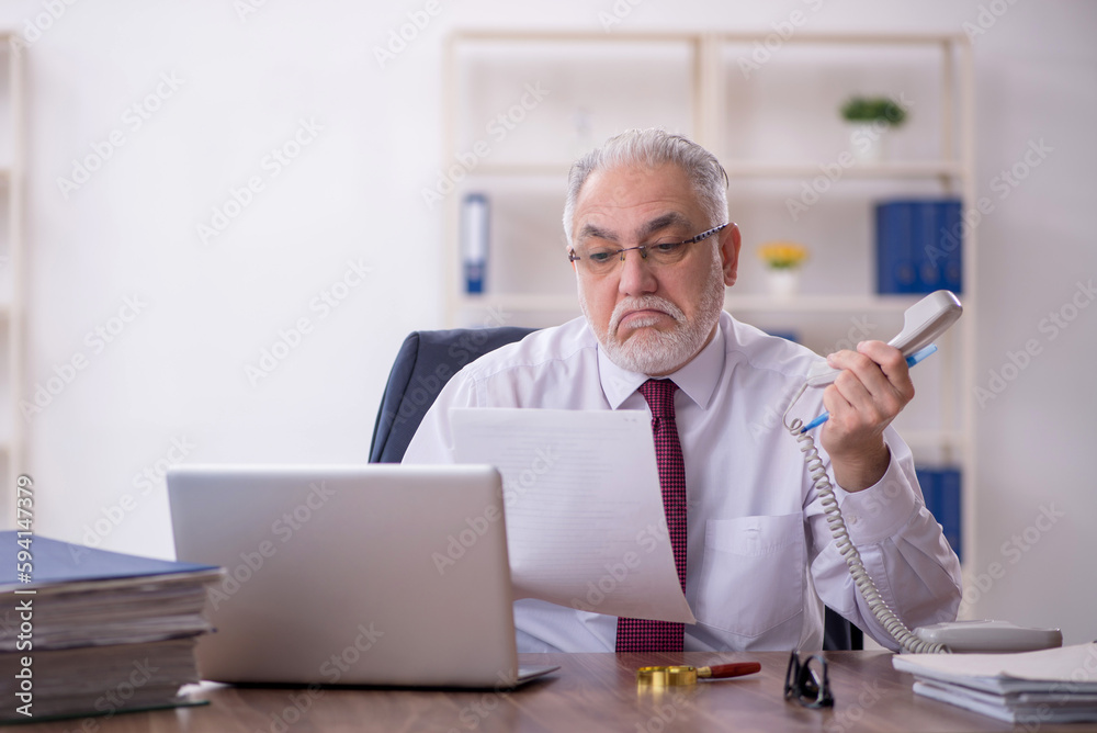 Old male employee and too much work in the office Old male employee and too much work in the office