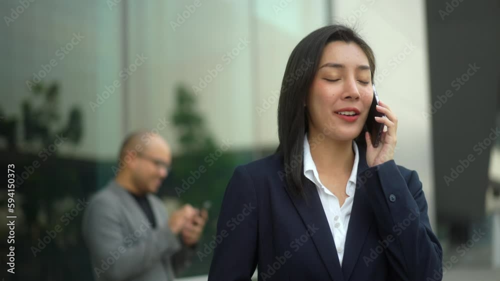 Confident business people using smartphone and application to communication at city business buildings. Successful attractive woman using cell phone in front modern office building. Working woman.
Confident business people using smartphone and application to communication at city business buildings. Successful attractive woman using cell phone in front modern office building. Working woman.