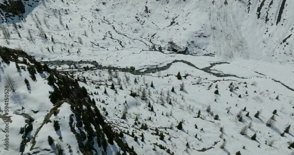 Aerial view of a creek surrounded by snow in the Austrian Alps Aerial view of a creek surrounded by snow in the Austrian Alps