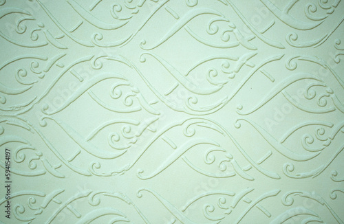 Green background from decorative plaster with abstract spots. Unusual green wall texture with beautiful patterns, creative surface background. Front covering for facing of buildings.