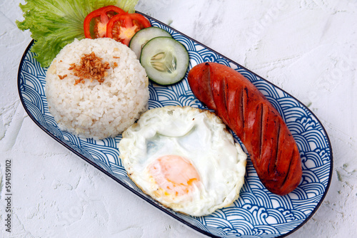 Freshly cooked Hungarian sausage served with fried rice and egg photo