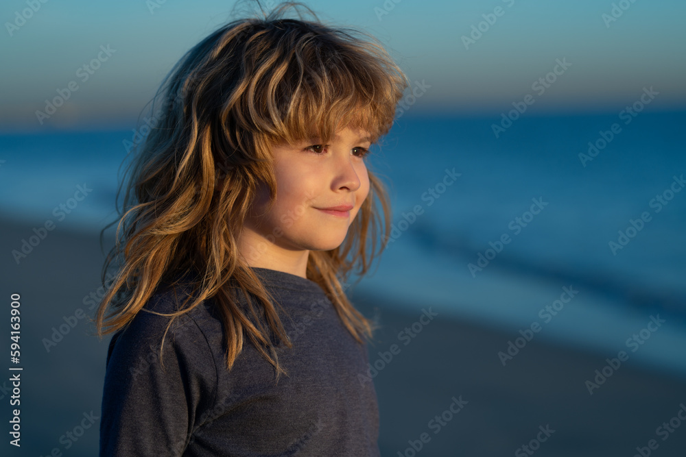 Portrait of kid boy in nature, park or outdoors. Close up face of happy child playing outdoors in summer park. Portrait of kid boy in nature, park or outdoors. Close up face of happy child playing outdoors in summer park.