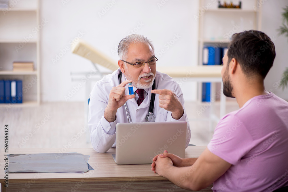 Young male patient visiting old male doctor