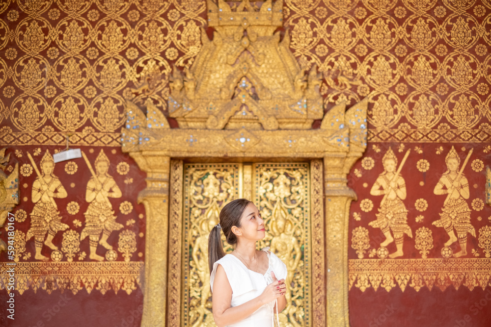Fototapeta premium Portrait of An Asian Woman at Wat Sene Souk Haram ,Luang Prabang, LAOS 