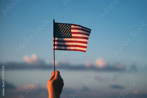 Man holding a waving american USA flag.