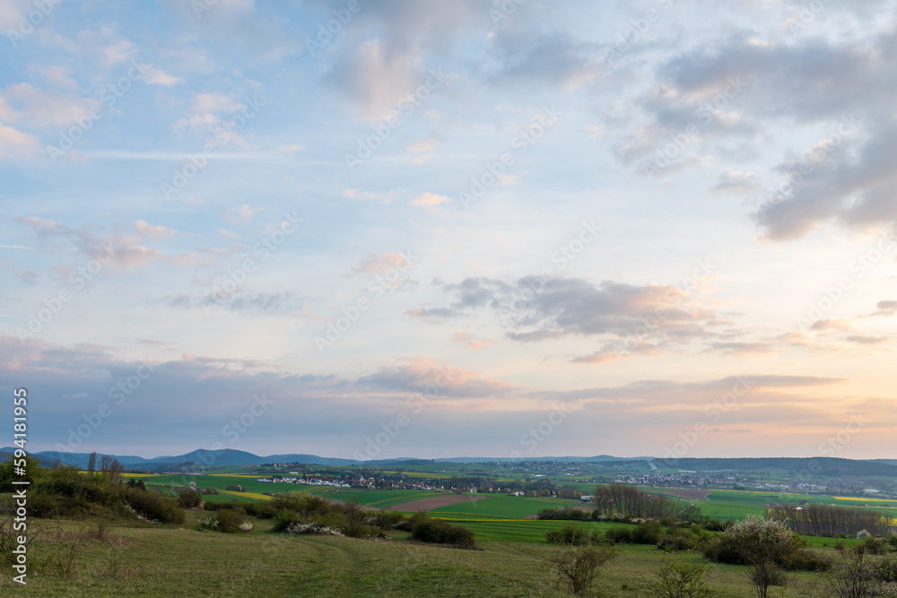 Fototapeta premium landscape with clouds and a village in spring