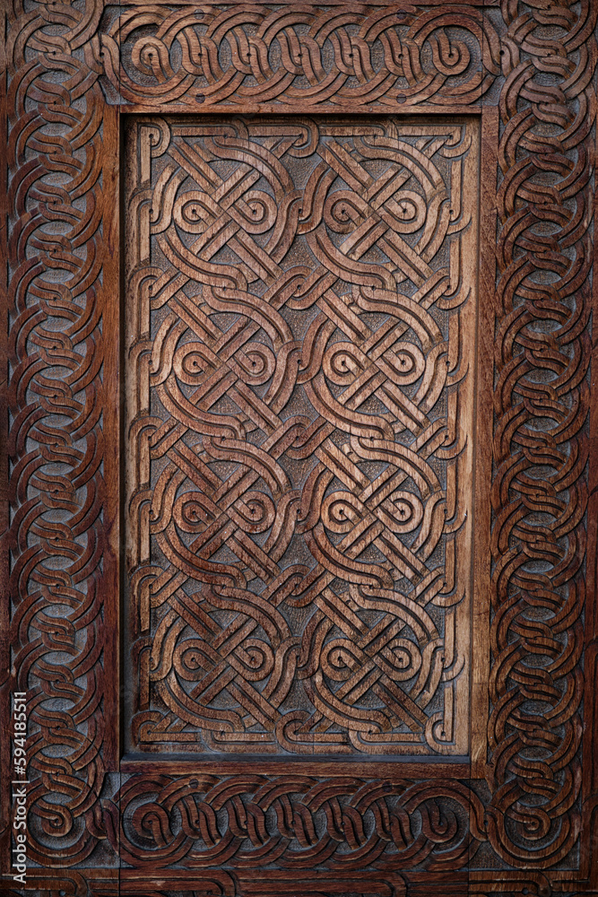Vertical image of a fragment of a wooden front door in an old building.