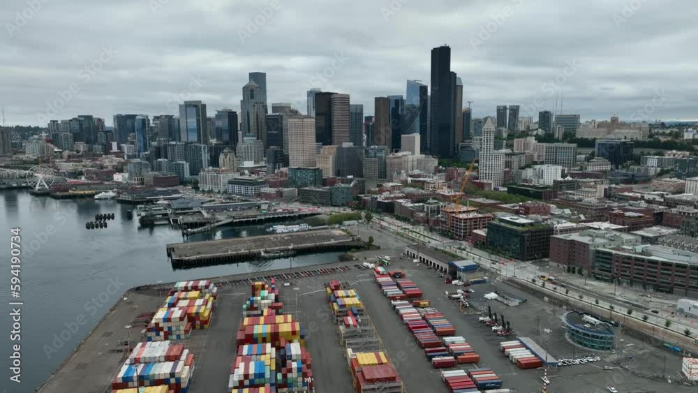 Aerial view of Seattle's shipyard with the city skyline in the backdrop on an overcast day.