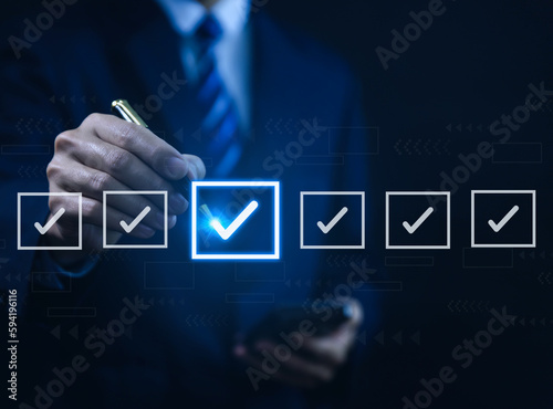Businessman ticking checkmark on a box in the list. Checklist Ideas in Business Survey items and questionnaires. 