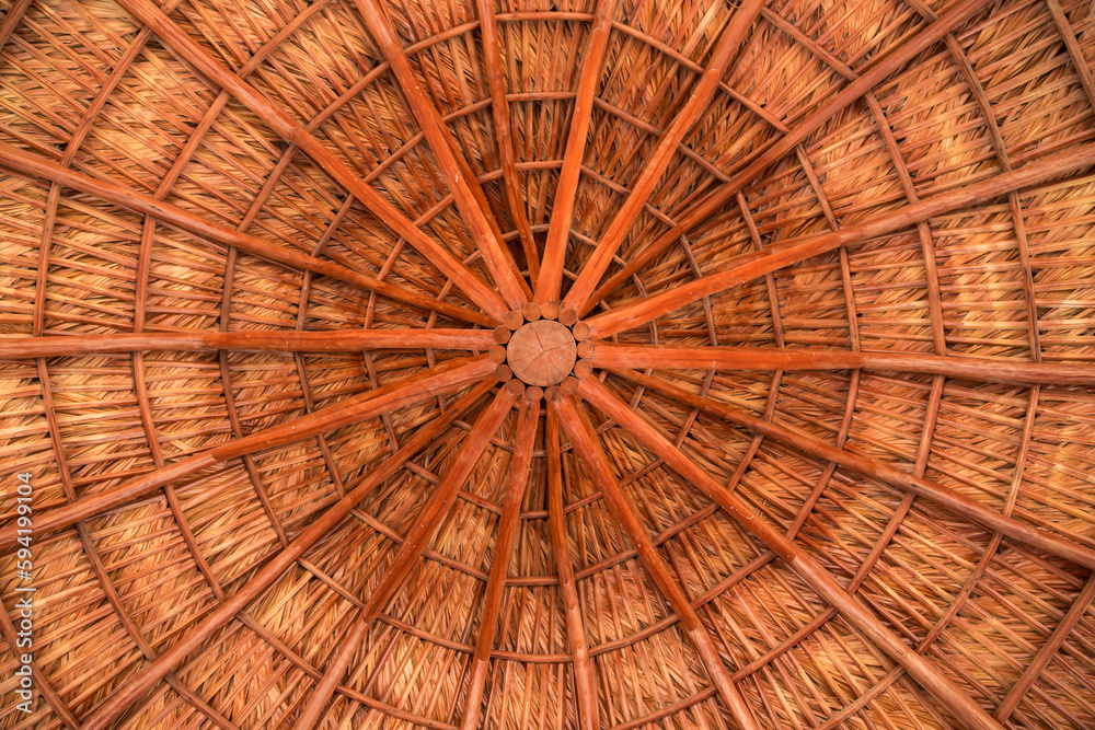 View of roof construction, of wooden gazebo in a garden.